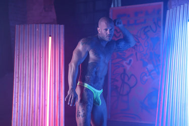 Chic angle of Sukrew Men's Sheer Low-Rise Thong in Acid Yellow, emphasizing the skimpy back and flexible fabric thong for a daring yet comfortable wear. Luxurious men's thong choice.